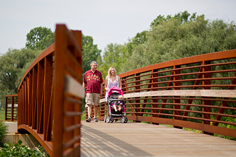 People Walking Accross a Pedestrian Bridge