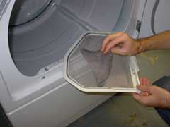 Person cleaning the clothes dryer lint filter