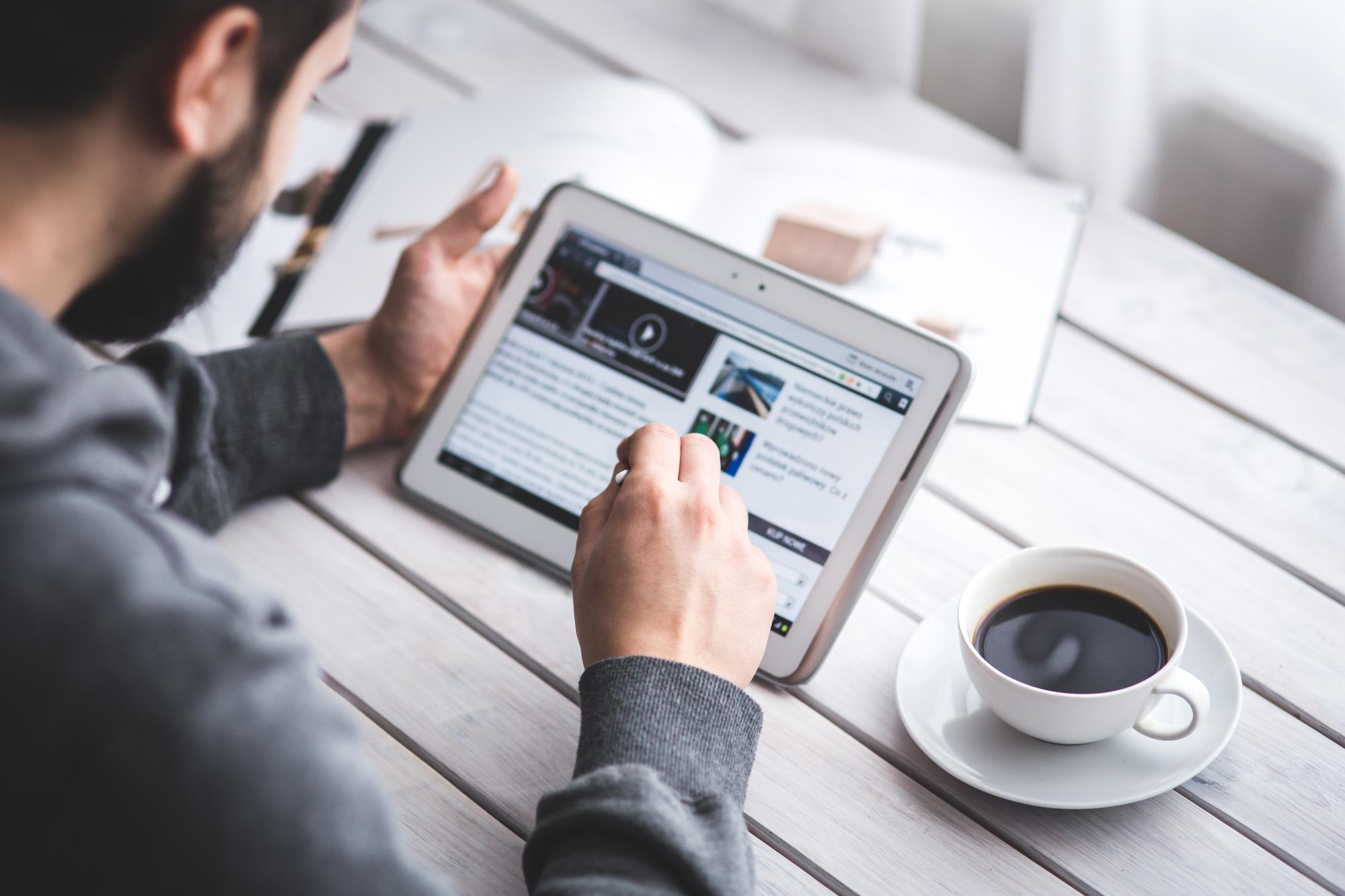 Man browsing internet on a tablet