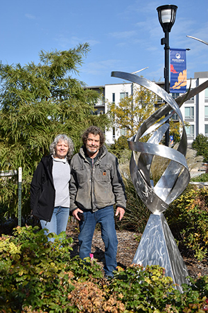 Bruce and Suzi Niemi next to their stainless steel sculpture in Drexel Town Square.