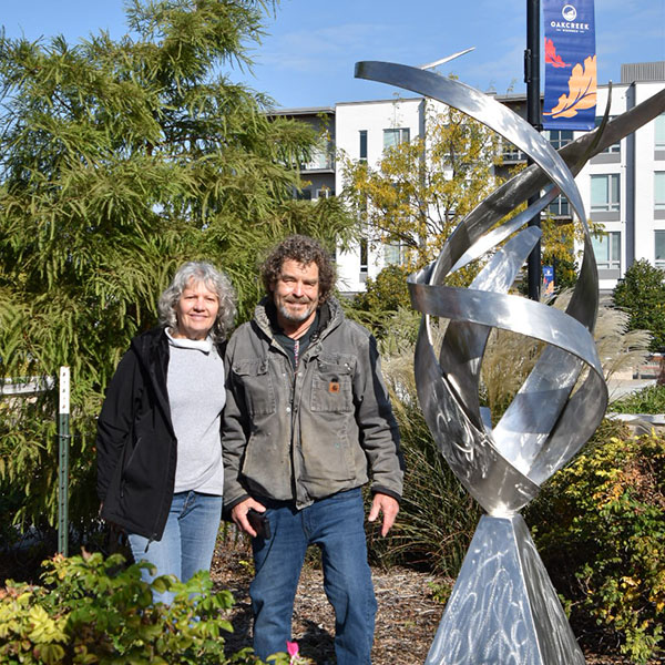 Bruce and Suzi Niemi next to their stainless steel sculpture in Drexel Town Square.