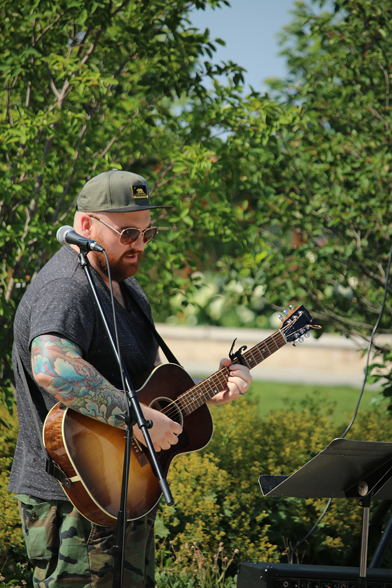 Musician with a guitar performing outdoors