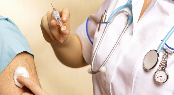 Practitioner giving a man an immunization