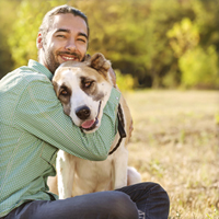 man hugging dog